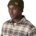 A male adult wearing the green beanie.