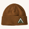 A brown Patagonia beanie with a triangle logo on the front on a cream background.