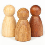 oak and sapeli wood with a natural oiled finish. Simple and tactile peg dolls for Waldorf story telling and small world play. Child paying with nins.