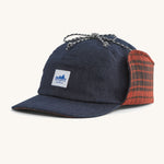 A blue Patagonia earflap cap with a check design on the inside