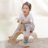 A child rocking on the PlanToys Palomino Rocking Horse. 