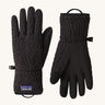 A pair of black Patagonia fleeced gloves on a cream background.