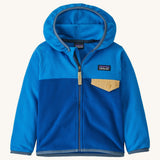 Blue kids Patagonia fleece with a gold pocket on a cream background