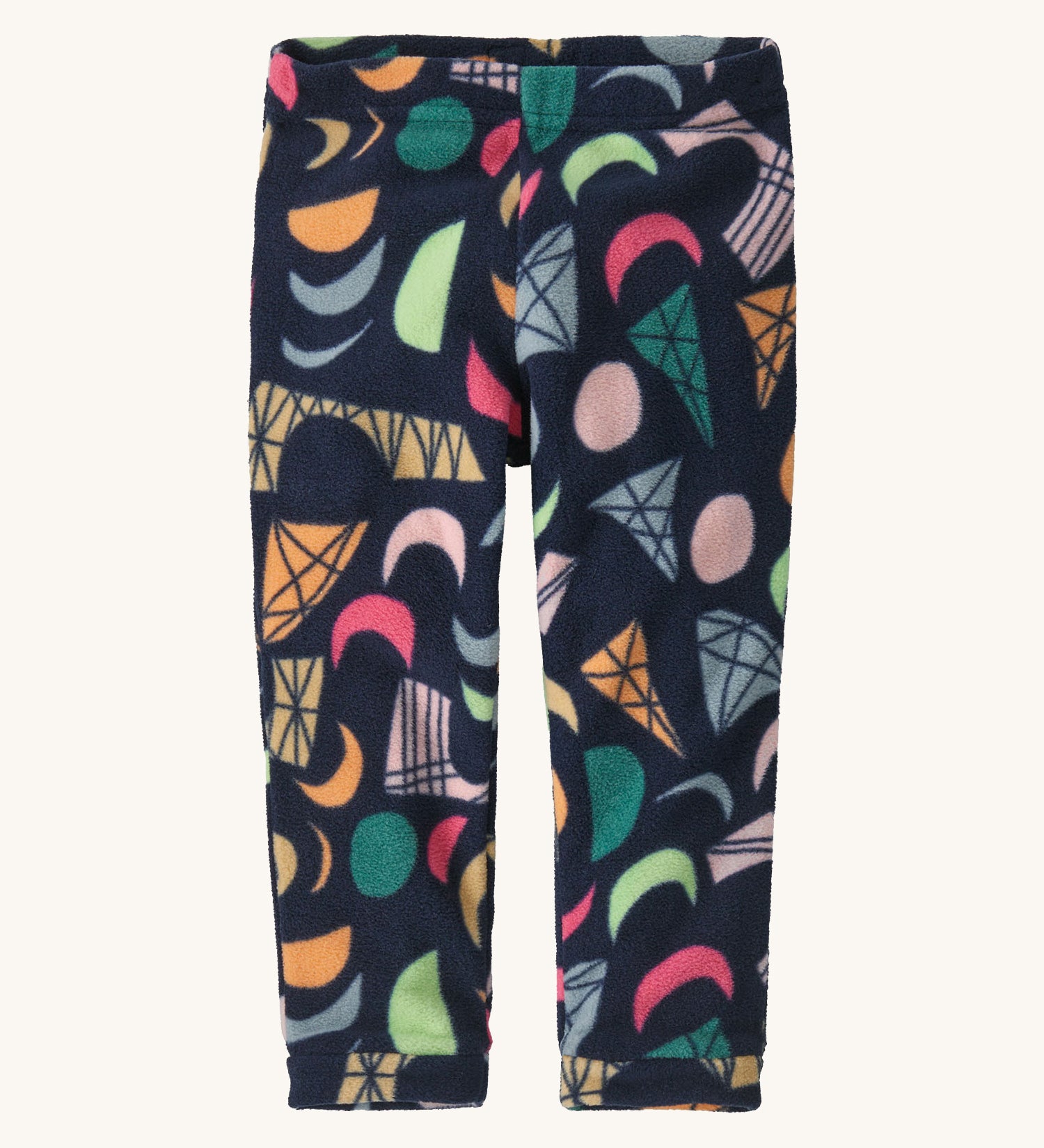 A pair of navy fleece trousers with different coloured shapes on a cream background