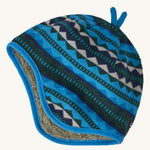 A blue reversible beanie with diamond patterns on a cream background
