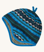 A blue reversible beanie with diamond patterns on a cream background