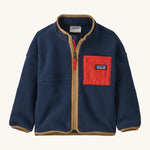 A navy with brown trim Patagonia fleece on a cream background