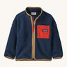 A navy with brown trim Patagonia fleece on a cream background