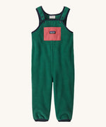 Green baby overalls on a cream background