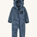 Dark blue fluffy kids all in one with little ears on the hood on a cream background
