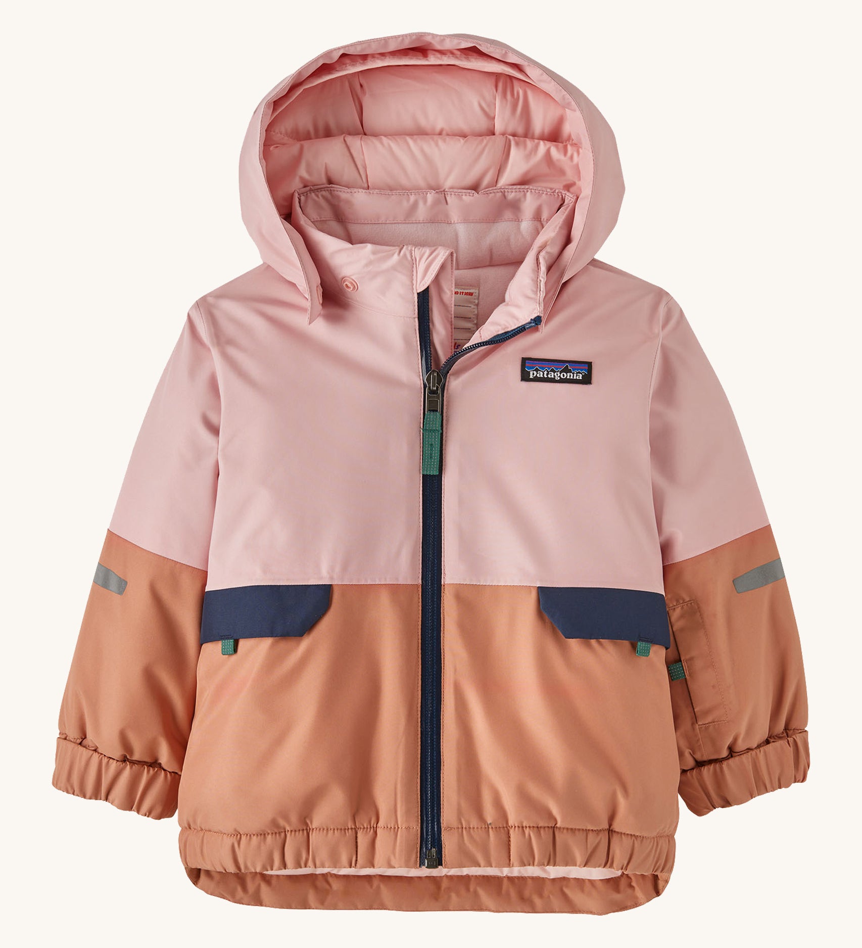 A light pink and orange hooded snow jacket on a cream background