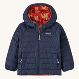 Navy Patagonia jacket with a fox reversible print on the inside on a cream background