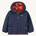 Navy Patagonia jacket with a fox reversible print on the inside on a cream background