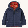 Navy Patagonia jacket with a fox reversible print on the inside on a cream background
