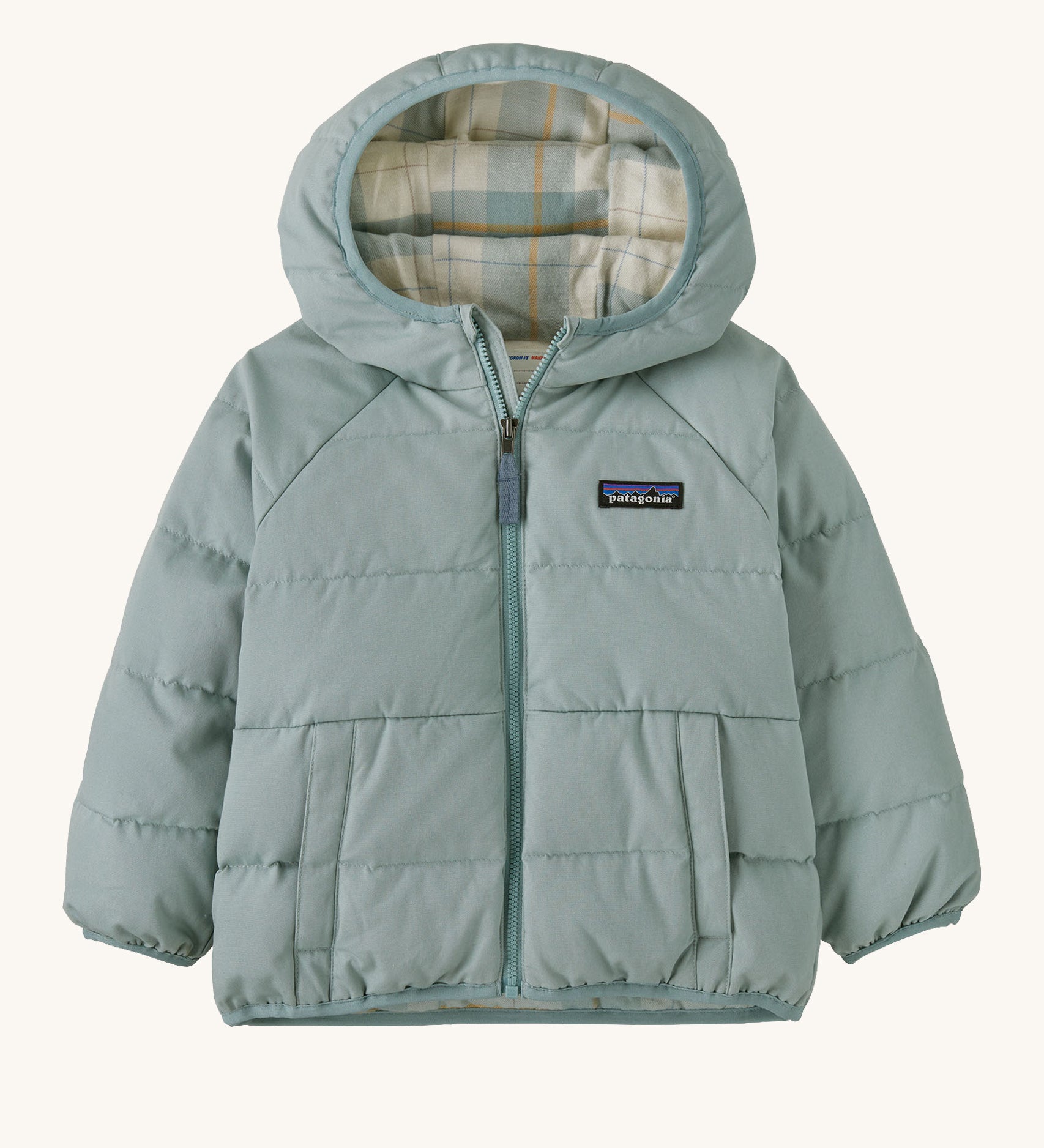 A light blue hooded jacket with a check design on the inside on a cream background