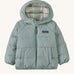 A light blue hooded jacket with a check design on the inside on a cream background