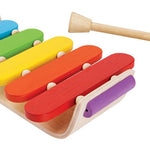 Plan Toys Oval Xylophone with rainbow keys and made from natural rubber wood. Sustainable musical instrument toys by Plan Toys. White background.