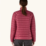Back of woman wearing Patagonia down sweater puffer jacket in Marion Red, falling at the hips with a tight/slim fit. 