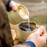 Woman pouring milk from a Klean Kanteen lowball tumbler with a small rise lid 