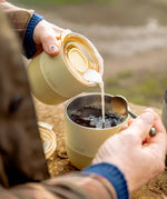 Woman pouring milk from a Klean Kanteen lowball tumbler with a small rise lid 