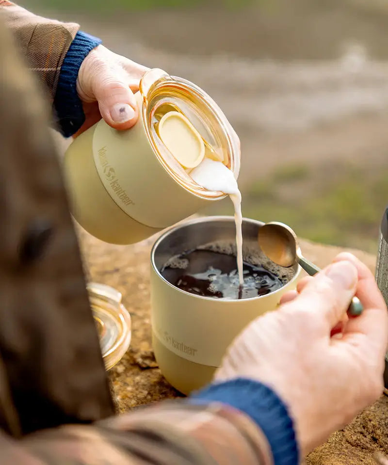 Woman pouring milk from a Klean Kanteen lowball tumbler with a small rise lid 