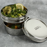 A close up of 2 of the tins from the stainless steel A slice of green chapra two tier round lunchbox  stacked on top of eachother 