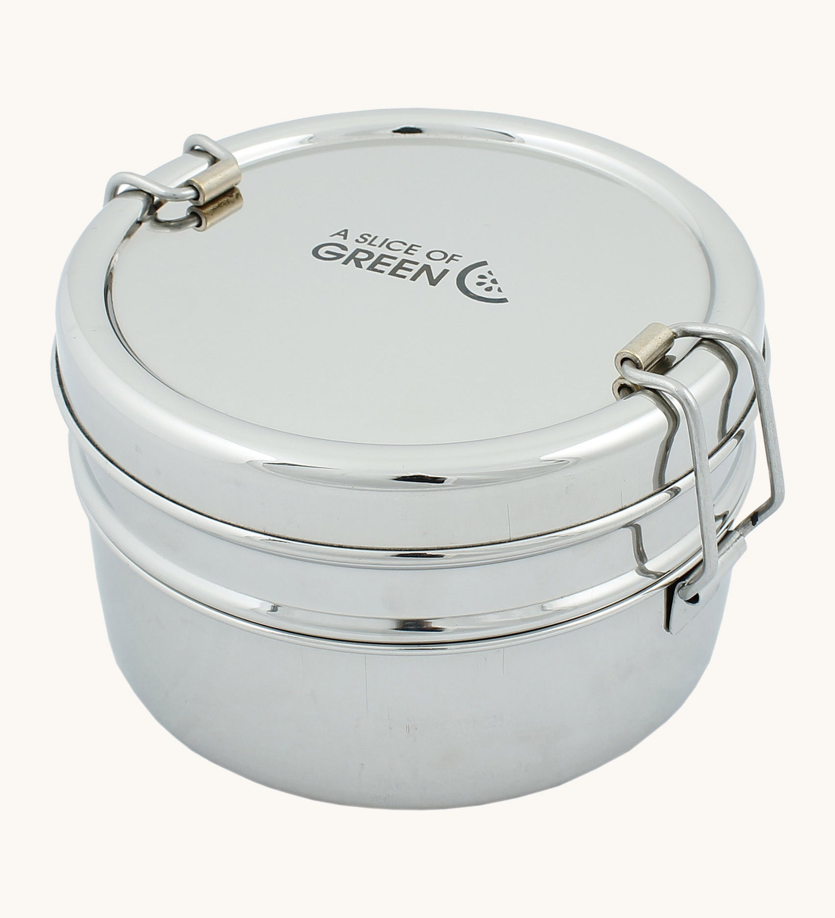 A slice of green chapra two tier round lunchbox available at Babipur. A two tier stainless steel lunchbox with a clip fastener on each side 