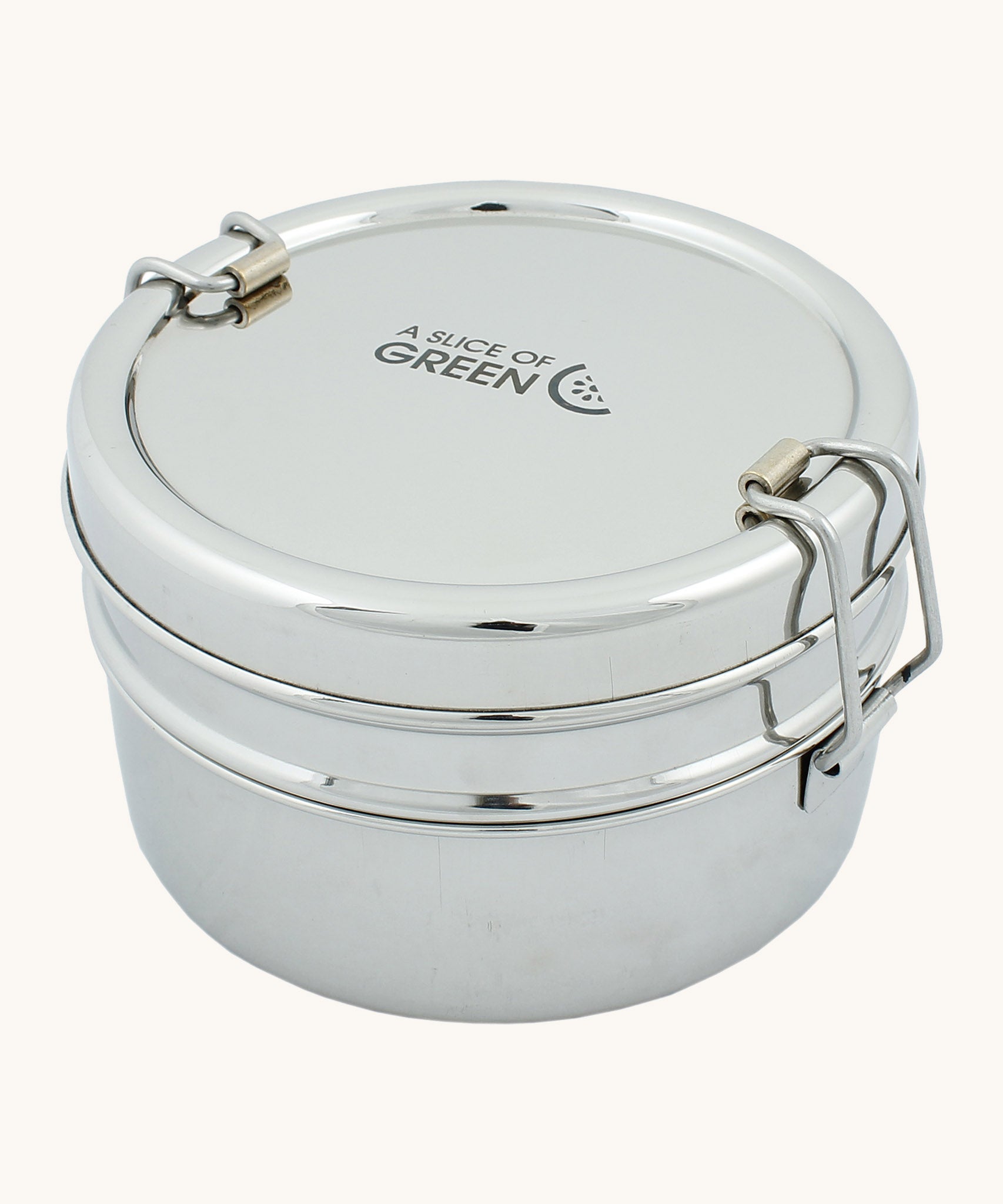 A slice of green chapra two tier round lunchbox available at Babipur. A two tier stainless steel lunchbox with a clip fastener on each side 
