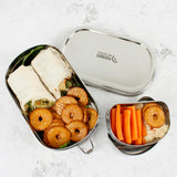 A top down image of the A slice of green oval lunchbox with mini container showing various food items in each container