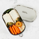 A top down image of the A slice of green oval lunchbox with mini container with food inside