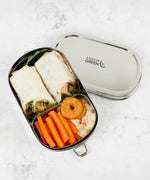 A top down image of the A slice of green oval lunchbox with mini container with food inside