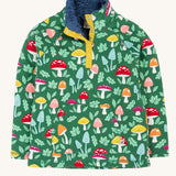 Frugi fun-guys snuggle fleece. A mushroom themed print on a green coloured background. 