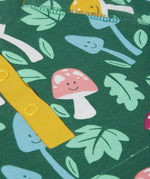 A super zoomed in close up of the Frugi fun-guys snuggle fleece. A multi-coloured mushroom themed print on a green coloured background. 