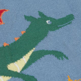 A close up of the green dragon on the front of the Frugi Organic Cotton Reva Dragon Skies Knitted Kids' Cardigan. This blue cardigan features a fun, colourful design featuring a green dragon, stars, rainbow, clouds and a mushroom. This cardigan is a part of a wide range of organic cotton clothing for children available here at Babipur. 