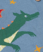 A close up of the green dragon on the front of the Frugi Organic Cotton Reva Dragon Skies Knitted Kids' Cardigan. This blue cardigan features a fun, colourful design featuring a green dragon, stars, rainbow, clouds and a mushroom. This cardigan is a part of a wide range of organic cotton clothing for children available here at Babipur. 