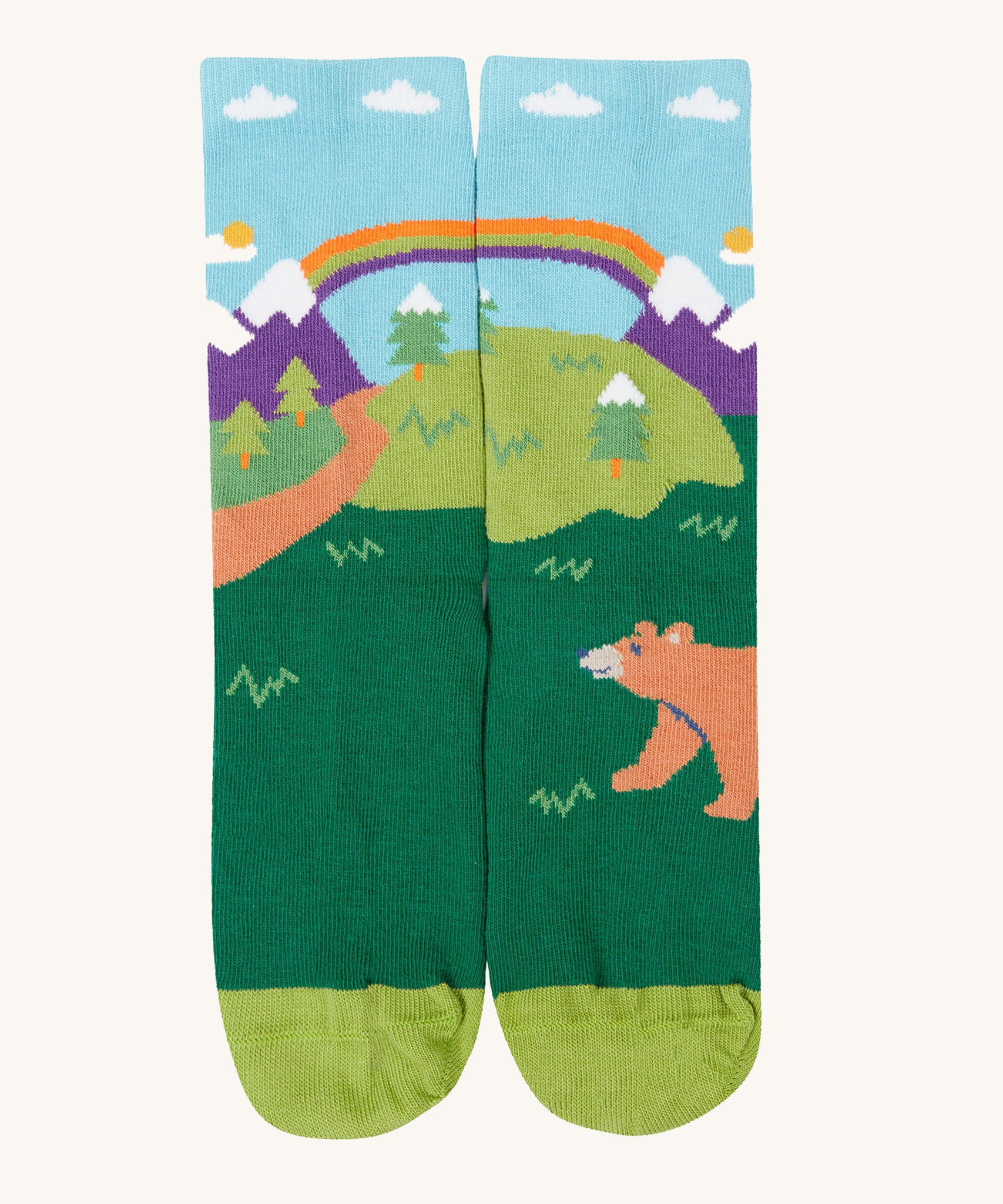 The bbear design organic cotton kids socks from the Frugi rock my socks adventure socks multi-pack. The design features a brown bear in a woodland setting with snow topped mountains in the background.