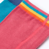 A close up of the waistband details on the tights in the Frugi Norah 2 pack. The rose pink tights have a multi-coloured striped design waistband and the hotchpotch design has a solid navy blue colour waistband.