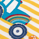 A super close up view of the embroidered rainbow detail on the tractor applique on the Frugi Orion Bumblebee tractor design long sleeved kids top.