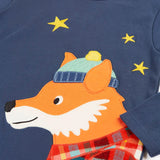Close up of the fox applique on the long sleeved top from the Frugi organic cotton caden check festive fox pyjamas. The fox is wearing a blue bobble hat and a check shirt.