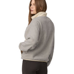 A person wearing the Patagonia Women's Synchilla Fleece Jacket showing the back and the collar, which is in an upright position to keep the neck warm
