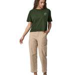 An adult wearing the Patagonia Women's Easy Cut Organic T-Shirt - Pine Green. The image shows a small earth logo on the front of the chest