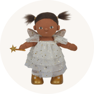 Olli Ella Dream Dinkum Freya Fairy, a toy baby doll with brown hair, brown skin dressed in a pretty fairy costume with a ruffled dress and wand, to represent new Olli Ella at Babipur.