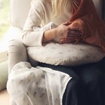 Avery Row Nursing Pillow - Coastline, a mother breastfeeding her baby with a brown muslin cover.