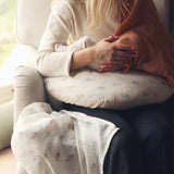 Avery Row Nursing Pillow - Coastline, a mother breastfeeding her baby with a brown muslin cover.