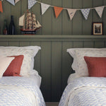 Coastline Avery Row Organic Cotton Bedding Set, with green painted walls, nautical ornaments and Coastline bunting