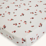 Avery Row Cotbed Fitted Sheet - Peaches. A light cream sheet with delicate peach print