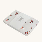 Avery Row Cotbed Fitted Sheet - Peaches on a plain background
