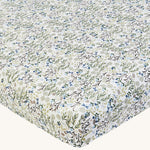 Avery Row Cotbed Fitted Sheet - Riverbank. A light cream sheet with beautiful and delicate Riverbank print