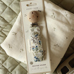 Avery Row Pacifier Holder - Riverbank. A beautfiful Riverbank nature inspired fabric, laid out on an Avery Row Nature Trail muslin cloth