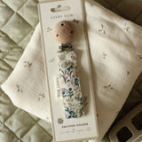 Avery Row Pacifier Holder - Riverbank. A beautfiful Riverbank nature inspired fabric, laid out on an Avery Row Nature Trail muslin cloth